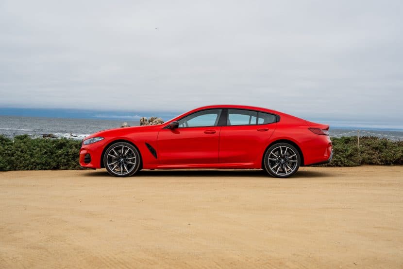 2026 BMW M850I HERITATE EDITION BRIGHT RED 06 2026 BMW M850I HERITATE EDITION BRIGHT RED side view parked